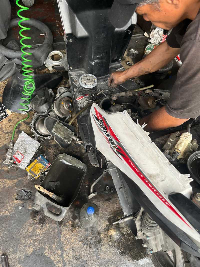 Mechanic servicing a motorcycle